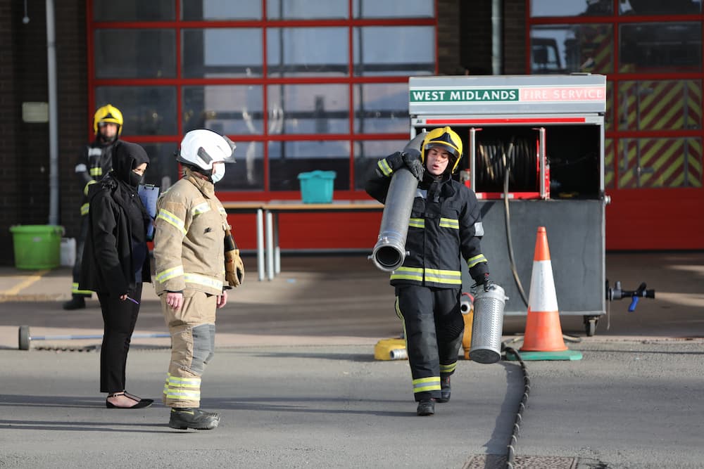 A firefighter candidate carrying bar bells