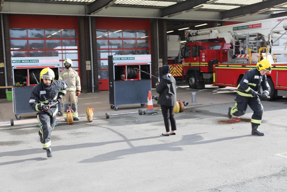 A firefighter candidate carrying bar bells