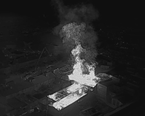 Black and white drone footage of fire at Zeenat Supermarket