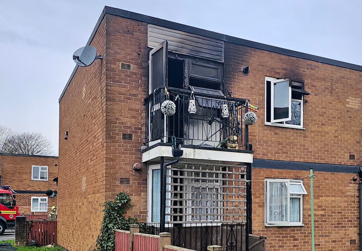 The rear of the maisonette after the blaze, showing smoke damage to the balcony area